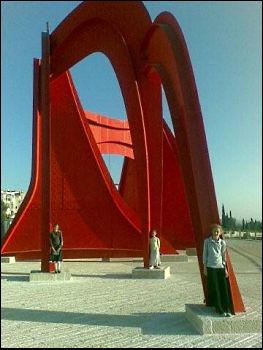 Three girls standing in modern sculpture in Jerusalem